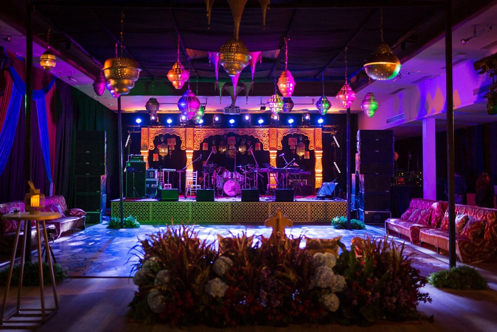 Sangeet colorful stage decor at an Indian wedding at Banyan Tree Phuket, Phuket, Thailand — planned by Niramit Creations.
