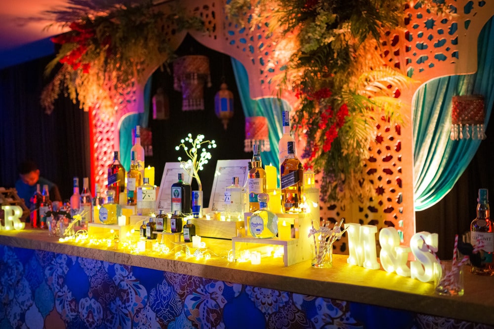 Sangeet draped colorful stage at an Indian wedding at Banyan Tree Phuket, Phuket, Thailand — planned by Niramit Creations.