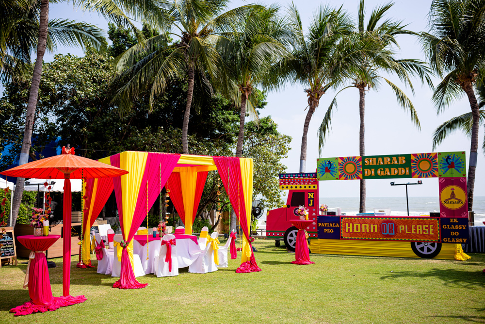 Haldi colorful beach stage at The Palayana Hua Hin, Hua Hin — Indian wedding planned by Niramit Creations.