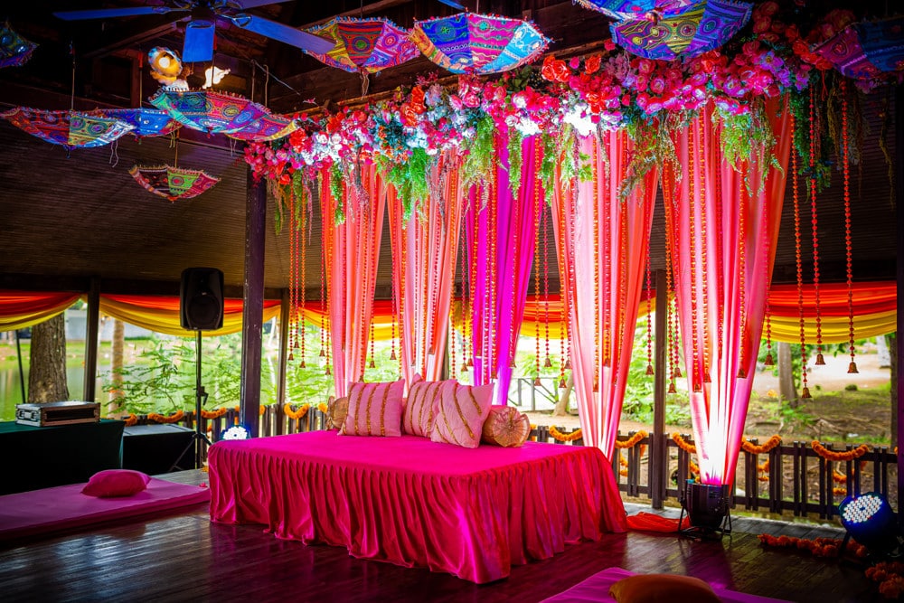 Mehndi stage floral backdrop at The Regent Cha-Am Beach Resort, Cha-Am — Indian wedding planned by Niramit Creations.