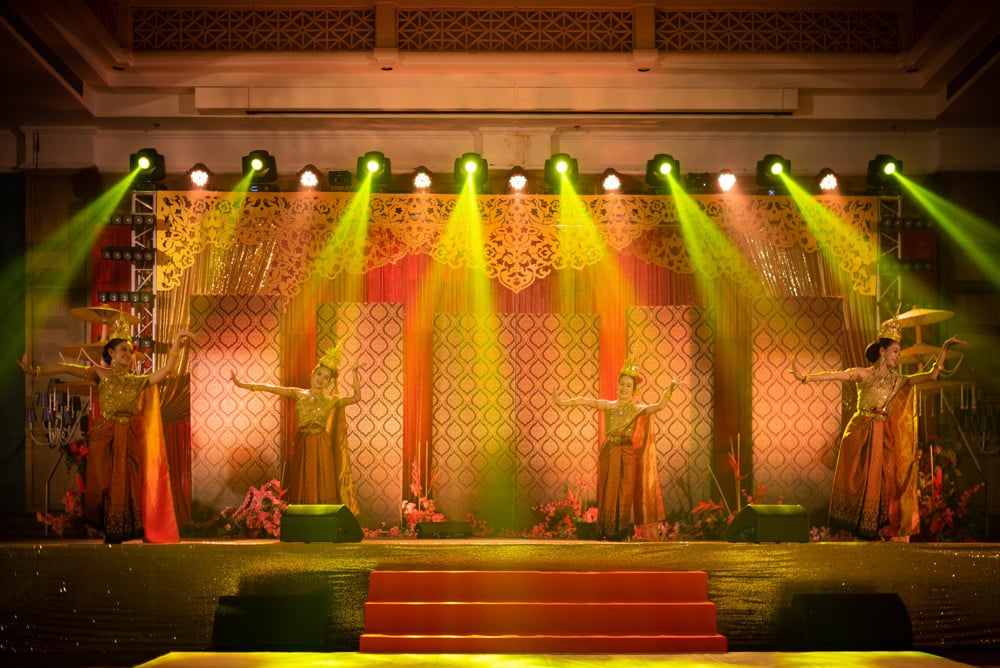 Reception colorful uplit stage at The Regent Cha-Am Beach Resort, Cha-Am — Indian wedding planned by Niramit Creations.