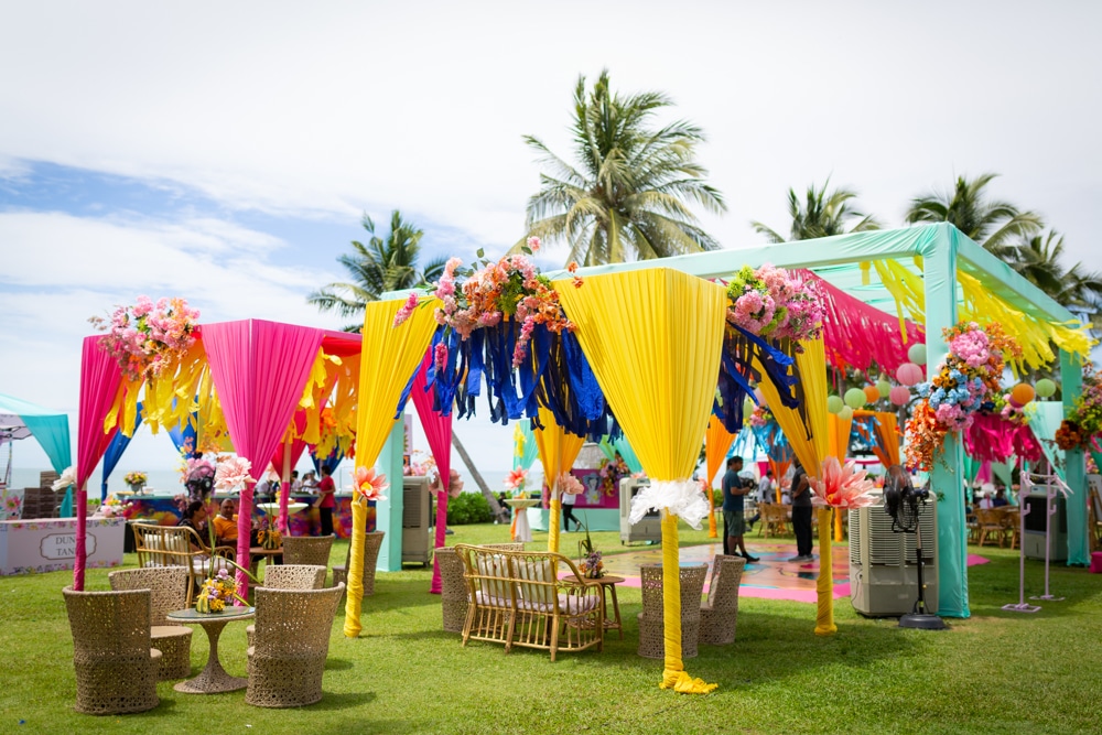 Carnival colorful draped stage at Sheraton Hua Hin Resort & Spa, Hua Hin — Indian wedding planned by Niramit Creations.